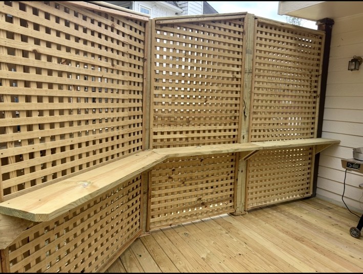 Custom lattice privacy railing with an integrated counter on a wood deck